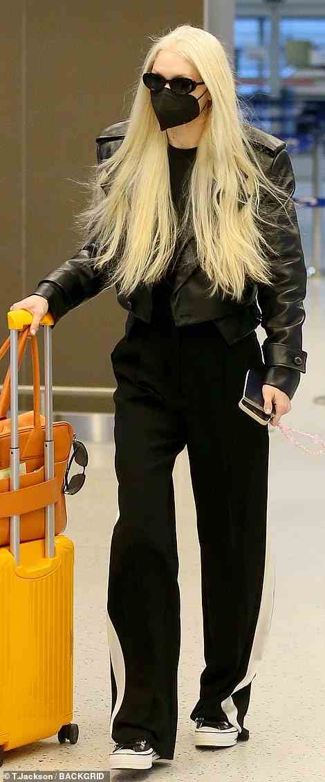 Bold: Gigi was seen with more yellowy platinum blonde hair shortly after touching down at JFK Airport in New York City on Wednesday