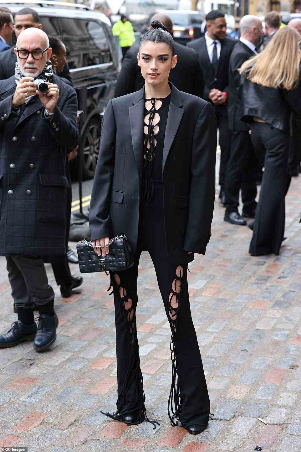 Skin: American singer Dixie D'Amelio, 20, flashed her flesh in a cut out jumpsuit which she paired with a tuxedo jacket and Burberry handbag