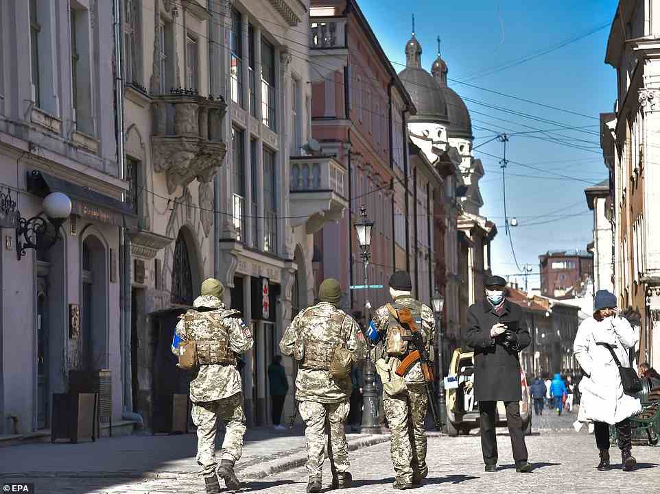 Soldiers patrol a street in Lviv, western Ukraine, as the Russian-waged war rages in the east and centre of the country for the sixteenth day on Friday, March 11