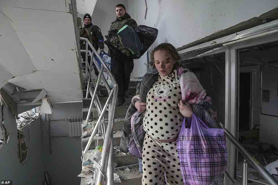 Mariana Vishegirskaya walks downstairs in of a maternity hospital damaged by shelling in Mariupol, Ukraine, Wednesday, March 9, 2022