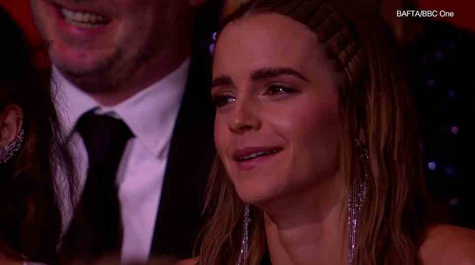 Not holding back: Emma was seen laughing during the show which took pops at Rowling