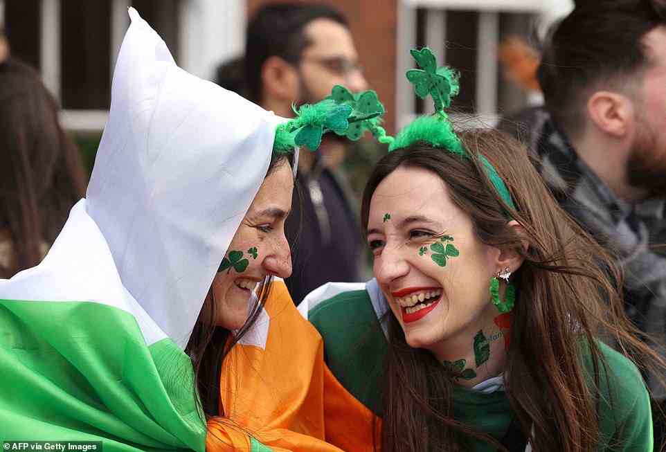 Leyre Munoz (L) and Andrea Izurdiaga (R), from Pamplona in Spain, smile during the annual St Patrick's Day parade in Dublin