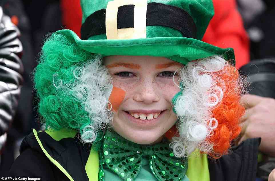 Eight-year-old Jacob O'Toole poses for a photograph during the annual St Patrick's Day parade in Dublin which returned for the first time in two years due to the Covid pandemic