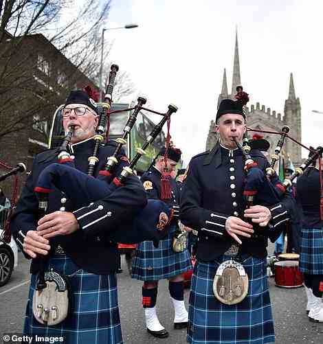 A pipe band play their instruments as they march through the streets to celebrate St Patrick's Day in Dublin today