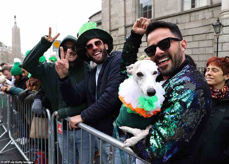 Revellers who dressed their dog up in an Irish-themed outfit cheered as they stood to watch the annual St Patrick's Day parade in Dublin