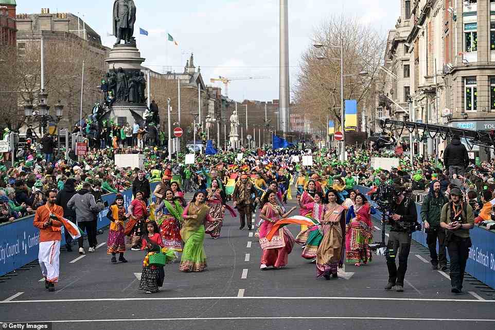 Crowds of revellers watched on as dancers performed through the streets of Dublin during the St Patrick's Day parade today