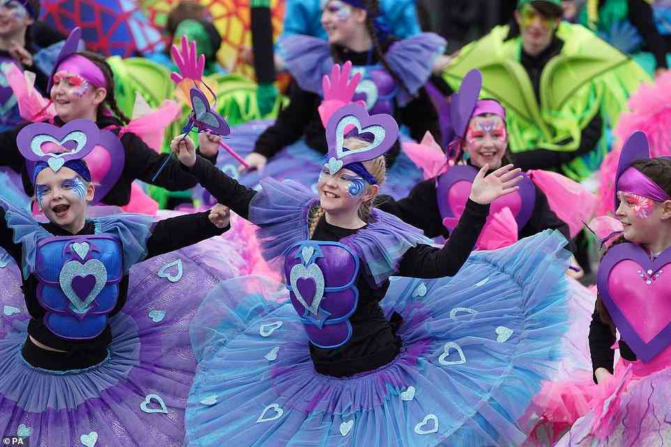 Young performers in colourful tutus and headdresses performed through the streets during the St Patrick's Day Parade in Dublin