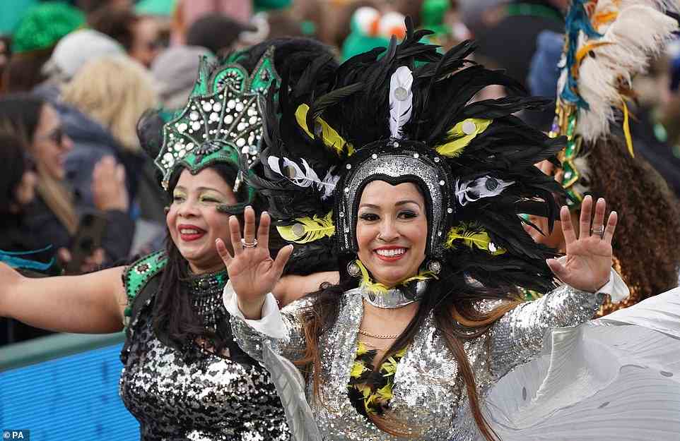 Performers donning elaborate headdresses and sequined outfits waved at the crowds as they travelled through the streets of Dublin as part of the St Patrick's Day Parade