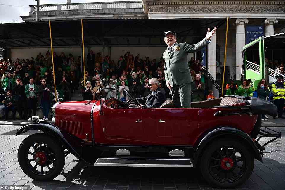 Hollywood star Reilly donned a flat cap and suit and was seen waving to crowds as he was driven through the St Patrick's Day parade in Dublin