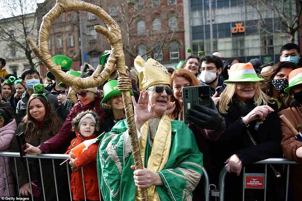 A man in fancy dress posed for selfies in the crowd during the St Patrick's Day parade in Dublin today