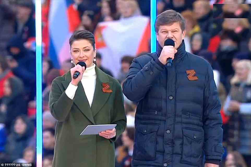 Pictured: Hosts wear a 'Z' on their coats as they present the celebration event. The 'Z' has become a symbol of pro-Russian nationalism since Putin launched his brutal invasion, as it is painted on many of Moscow's military vehicles