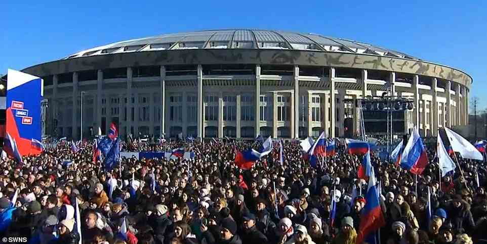 Pictured: Crowds are seen outside the stadium on Friday. Moscow police said more than 200,000 people were in and around the Luzhniki stadium for the rally