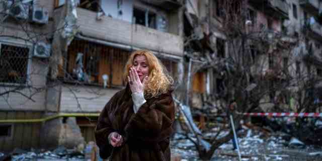 Natali Sevriukova reagiert neben ihrem Haus nach einem Raketenangriff auf die Stadt Kiew, Ukraine, Freitag, 25. Februar 2022.