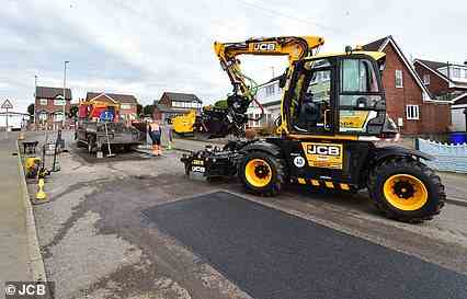 Job done: The JCB PotholePro is parked up with the road repair complete as the hand lay team continue breaking their 12m² with a hand held breaker