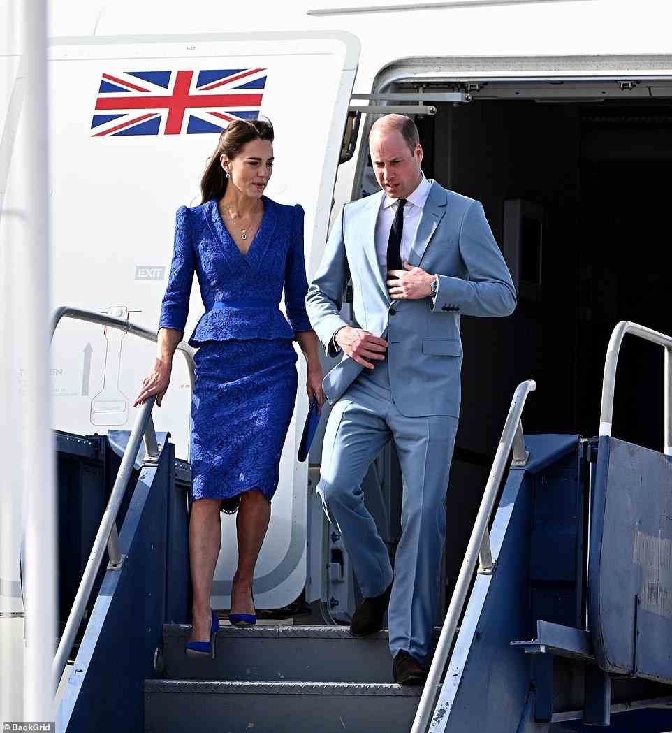 The Duchess of Cambridge cut a chic figure in a royal blue dress and matching purse, while the Duke looked smart in a grey suit and tie as they received a warm official welcome at the Belize airport.