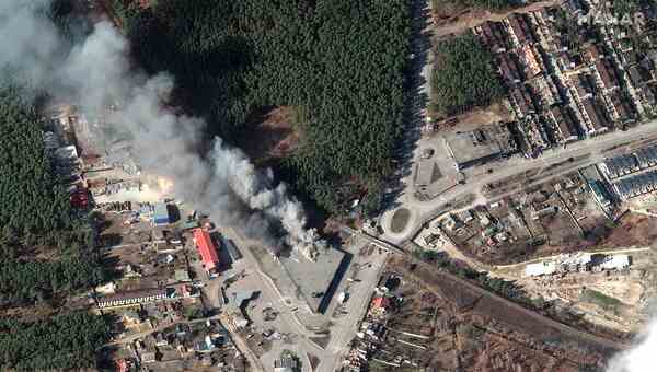 A satellite image of a burning triangular building.