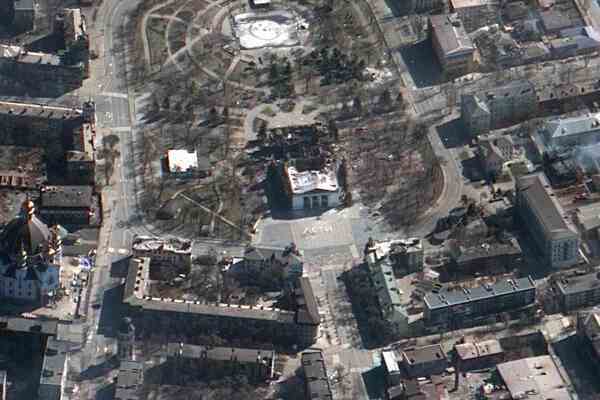 A satellite image of a large destroyed building in a courtyard.