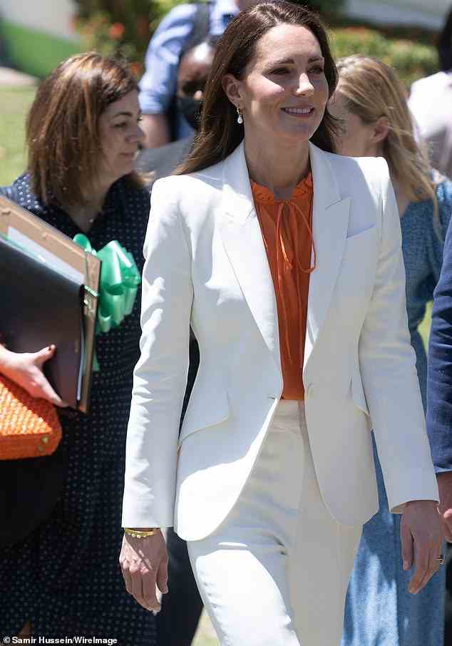 By her side: Private secretary Hannah Cockburn-Logie OBE, a former diplomat who joined the team in 2020, is seen carrying a gift for the Duchess as she walks behind her in Jamaica