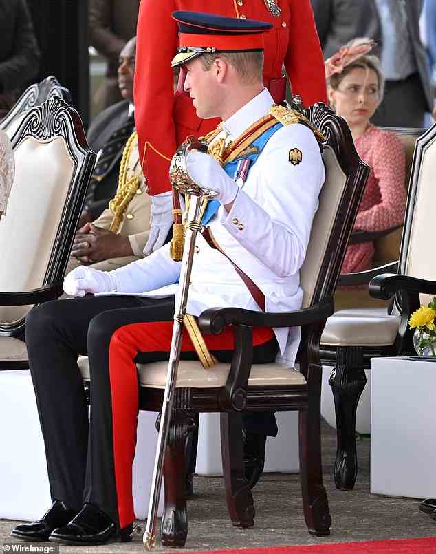 Royal insider: Ms Barrows sits behind Prince William at a military parade in Kingston yesterday