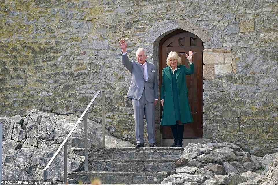 Britain's Prince Charles and Camilla, Duchess of Cornwall wave as they leave Cahir Castle during their visit to Cahir