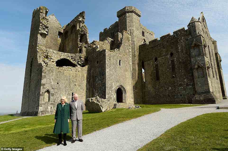 Duchess of Cornwall and Prince Charles pose in front of the cathedral during a visit at the Rock of Cashel on March 25, 2022 in Tipperary, Ireland