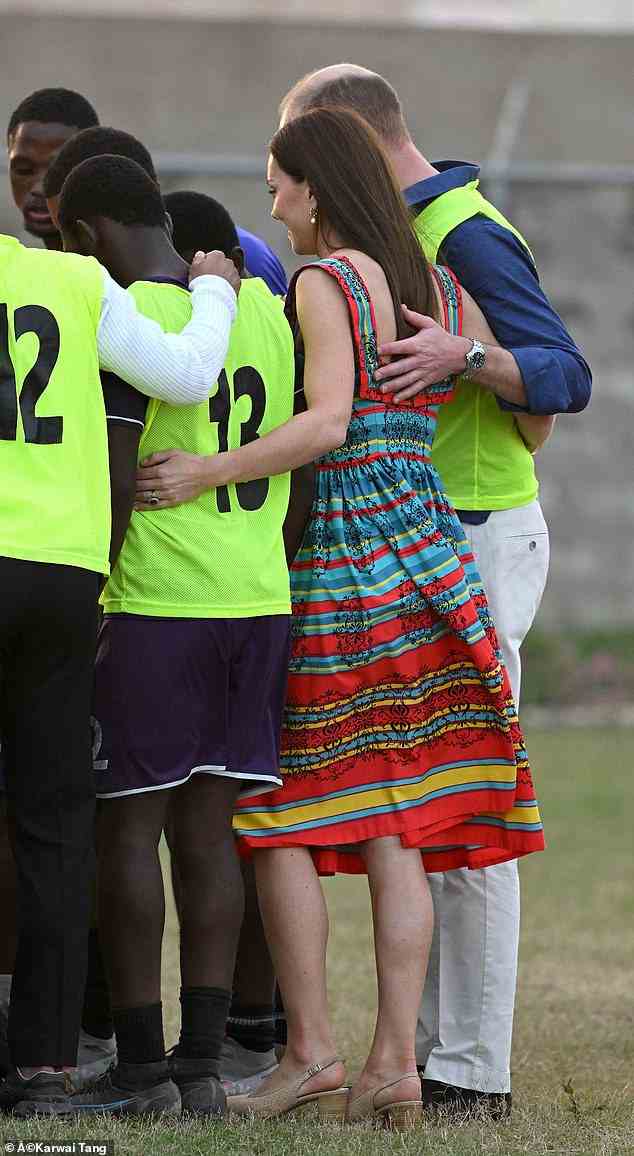 Go team! Sporting a very colourful dress, Kate leaned in for a pet talk as Prince William gently placed his hand on the middle of her back on Tuesday