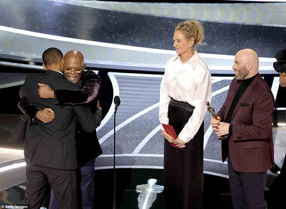 Will Smith accepts the Actor in a Leading Role award for King Richard from Samuel L. Jackson, Uma Thurman, and John Travolta onstage during the 94th Annual Academy Awards at Dolby Theatre