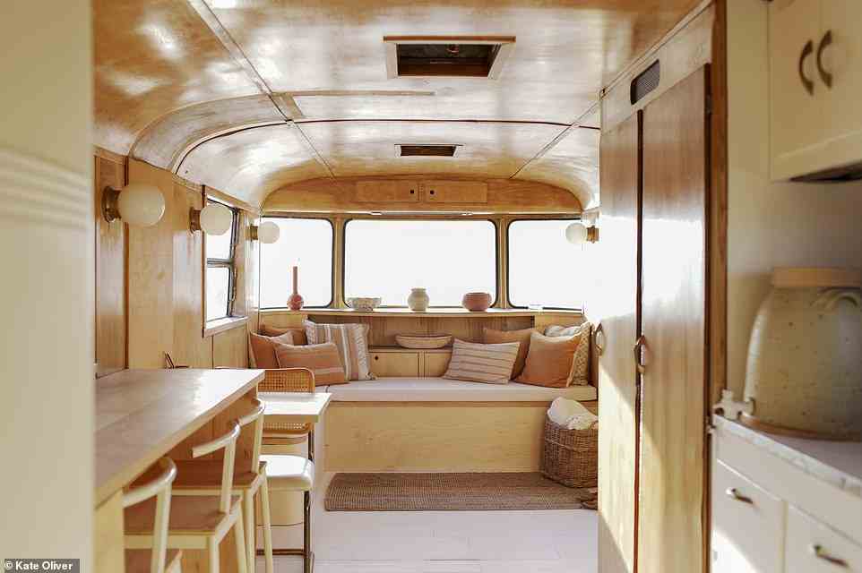 Parked up next to their home in the Mojave Desert, Kelly Brown and Bryce Ehrecke's 31ft trailer was inspired by wabi-sabi aesthetics, according to the book. The soft, warm tones are inspired by the colours of the desert, we're told, reflecting the 'sand and stone, the rusts and golds of dried desert buckwheat, and other desert flora'. By recycling existing kitchen units and buying vintage fixtures, the project was built in just two months on a budget of $16,000 (£12,000), the book reveals. Follow along - @kellybrownphoto and @crenaturalbuilding