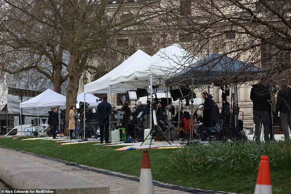 Television broadcasting staff gather outside Westminster Abbey this morning ahead of Prince Philip's memorial service