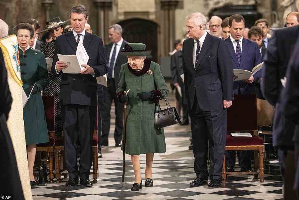 The Queen walks towards her seat at Westminster Abbey after being accompanied down by the aisle by Prince Andrew today