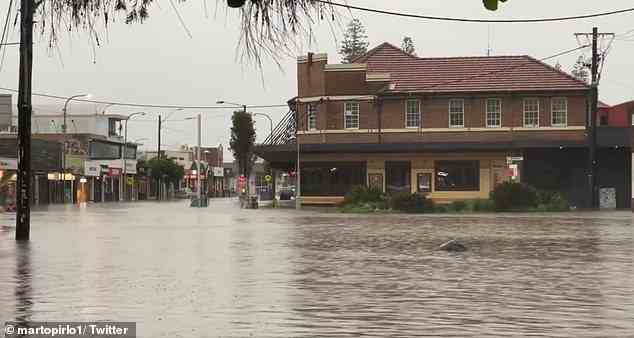 The flood emergency continues to unravel across northern NSW with weary residents rushing to salvage anything they can in the famous tourist town (pictured, floods in Byron's CBD)