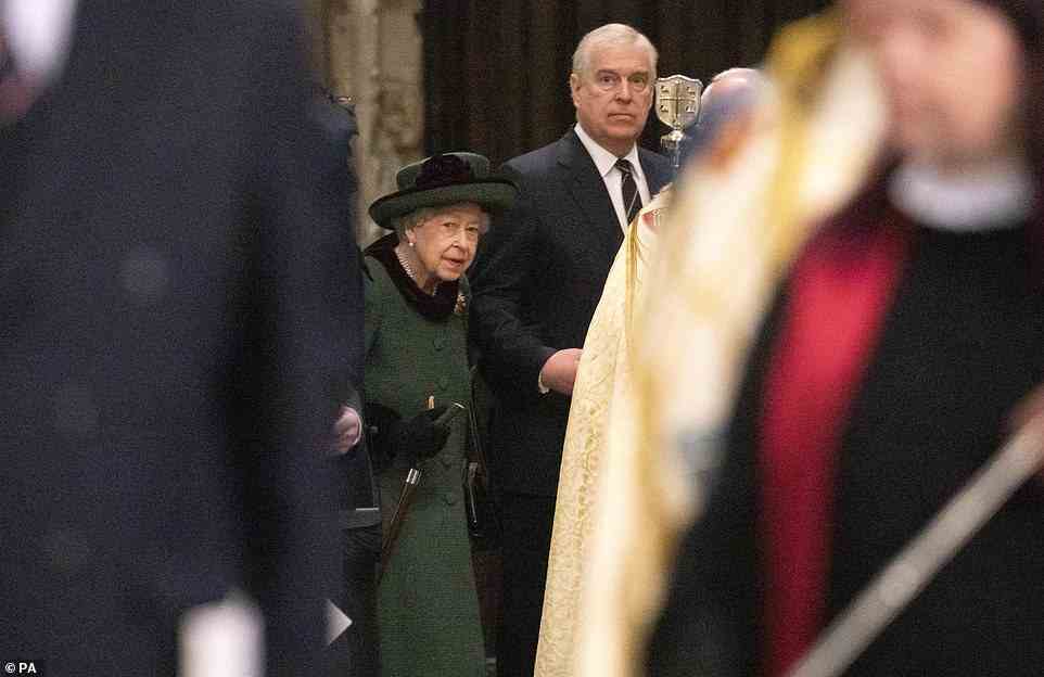 The Queen arrives at the service holding the Duke of York by the elbow with her left hand and her stick with the right