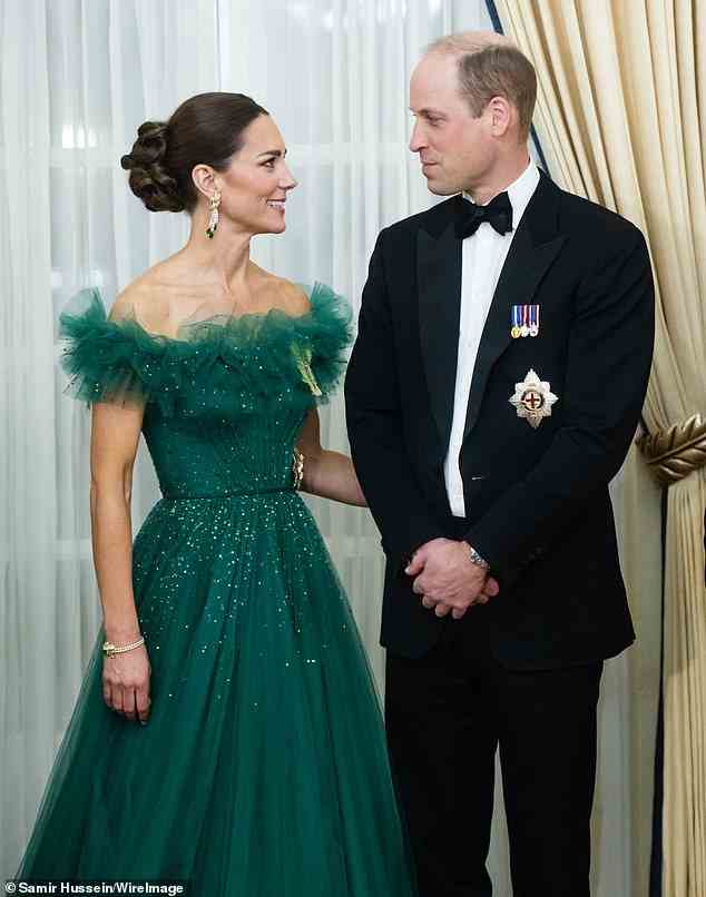 The look of love: A comforting Kate gazed into William's eyes and placed a hand on his back as he prepared to address the room during a dinner hosted by the Governor General of Jamaica at King's House on Wednesday