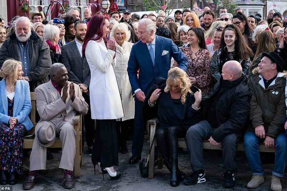 A royal gentleman! The Prince of Wales lends Letitia Dean his coat during a visit to the set of EastEnders at the BBC studios in Elstree, Hertfordshire