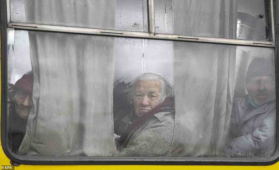 Pictured: Ukrainian refugees look out a bus window as they leave their homes in the commuter town of Bucha on April 3