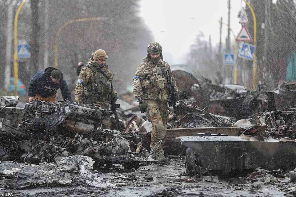 Ukrainian Soldiers inspect destroyed Russian military machinery in Bucha after recapturing the town from Russian forces