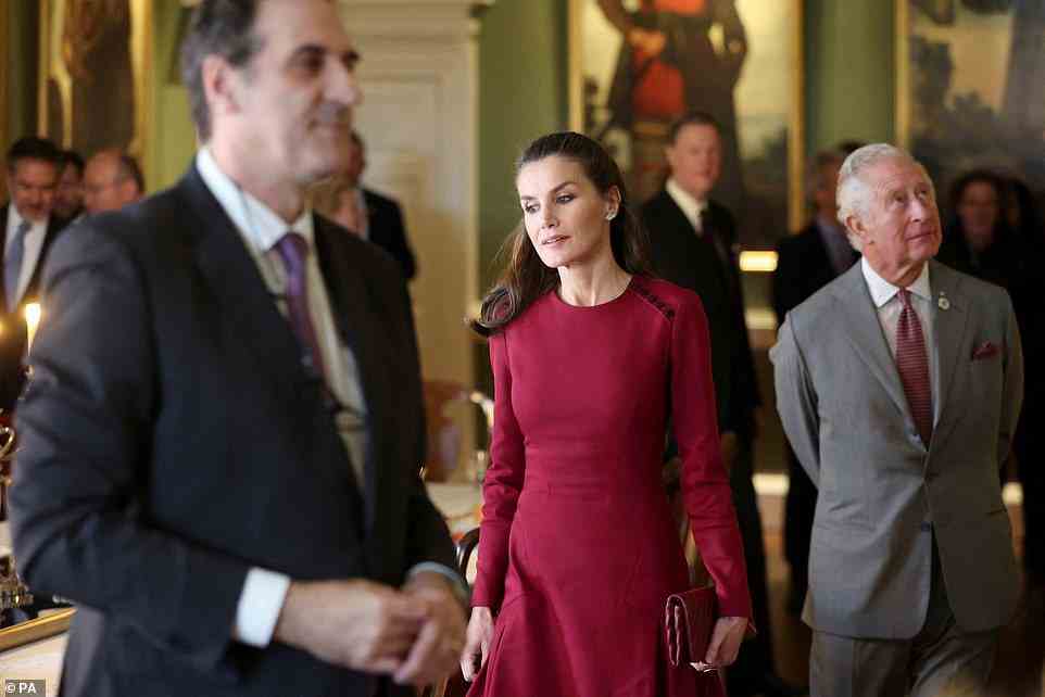 Queen Letizia opted for a raspberry pink gown for the occasion, which she perfectly matched with Prince Charles' tie (pictured)
