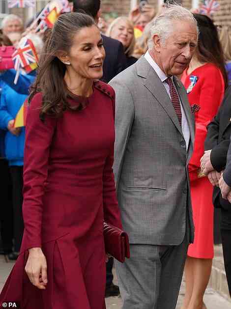 The mother-of-two cut an elegant figure in a raspberry red dress for the outing, which she paired with matching accessories