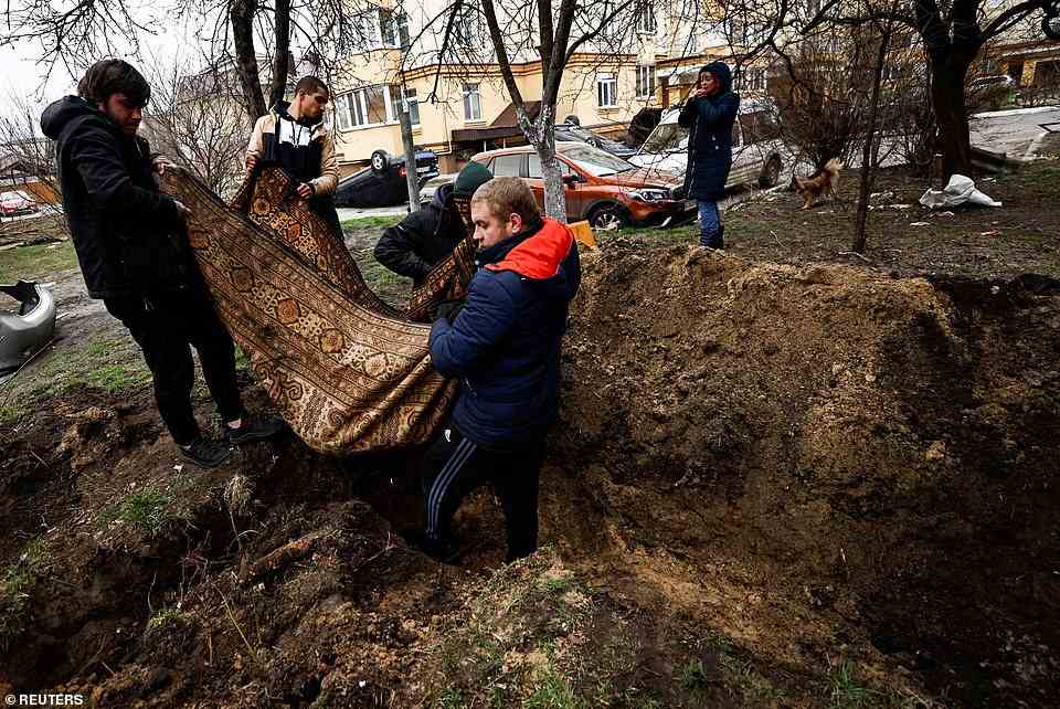 Serhii Lahovskyi, 26, and other residents carry the body of Ihor Lytvynenko to bury him in Bucha, April 5, 2022