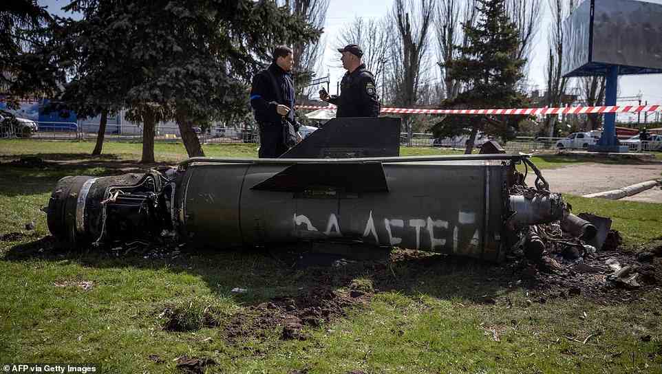 Ukrainian police inspect the remains of a large rocket with the words 'for our children' in Russian next to the main building of a train station in Kramatorsk, eastern Ukraine, that was being used for civilian evacuations. It was hit by a rocket attack killing at least 30 people, on April 8, 2022