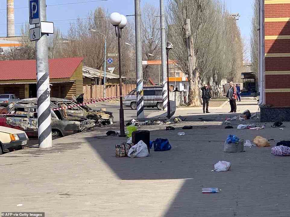 This general view shows personal belongings of victims and burnt-out vehicles after a rocket attack on the railway station in the eastern city of Kramatorsk, in the Donbass region on April 8, 2022