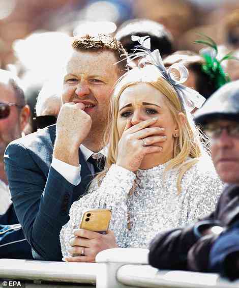 Meanwhile, this couple looked aghast during a race - perhaps worried they were going to lose money on a bet