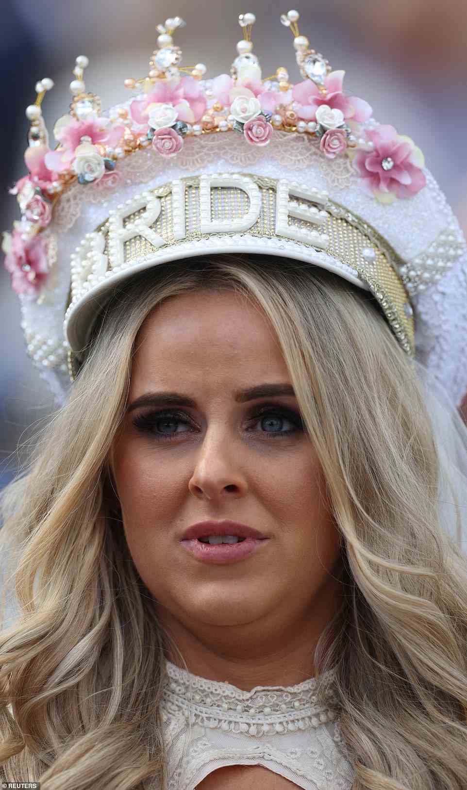 One woman seemed to be celebrating more than horse racing today, wearing a lavish beaded headpiece that says 'bride'