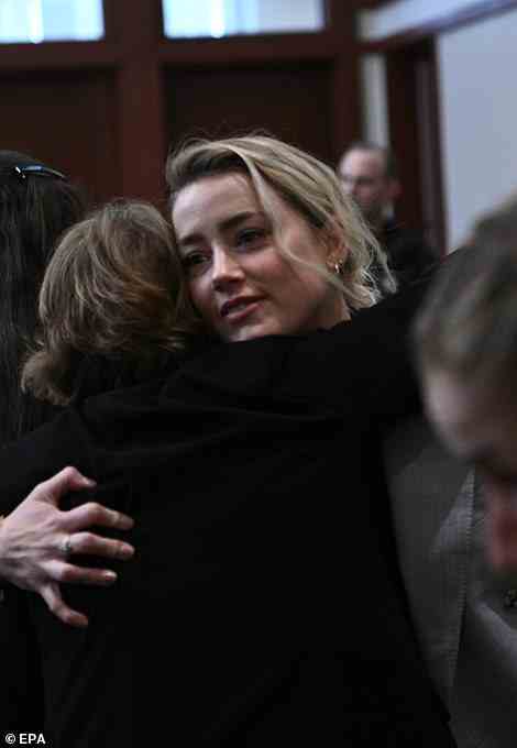 Amber Heard is seen in court giving a woman a hug before opening statements begin