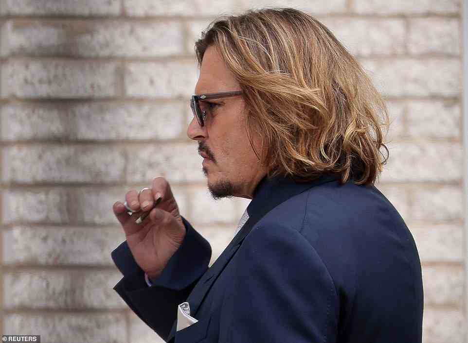 Depp is seen taking a smoke break outside the courthouse after opening statements