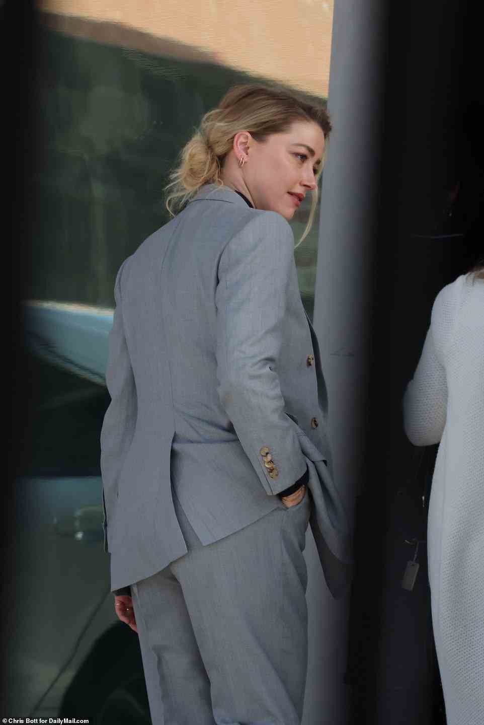 Amber Heard wore a gray suit and black top in court and appeared tense as she entered the courthouse Tuesday