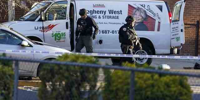 Bomb squad personnel search a U-Haul van during an ongoing investigation in the Brooklyn borough of New York, Tuesday, April 12, 2022.
