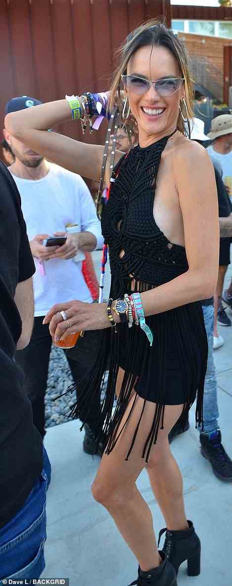 Festival fashion: The veteran supermodel, 41, wore a black halter top with long tassels, black shorts, and black booties with a heel as she enjoyed herself at the Rolling Stone Meta pool party