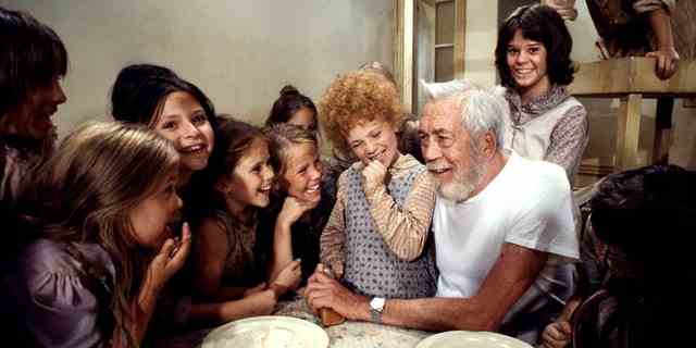 John Huston, director, with Aileen Quinn and other cast members of "Annie."