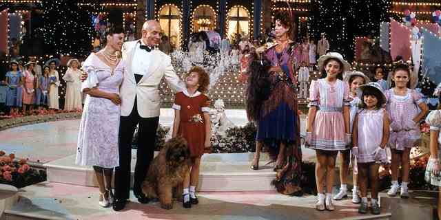 Albert Finney, Aileen Quinn, Carol Burnett and others on stage in scene from the film "Annie," 1982.